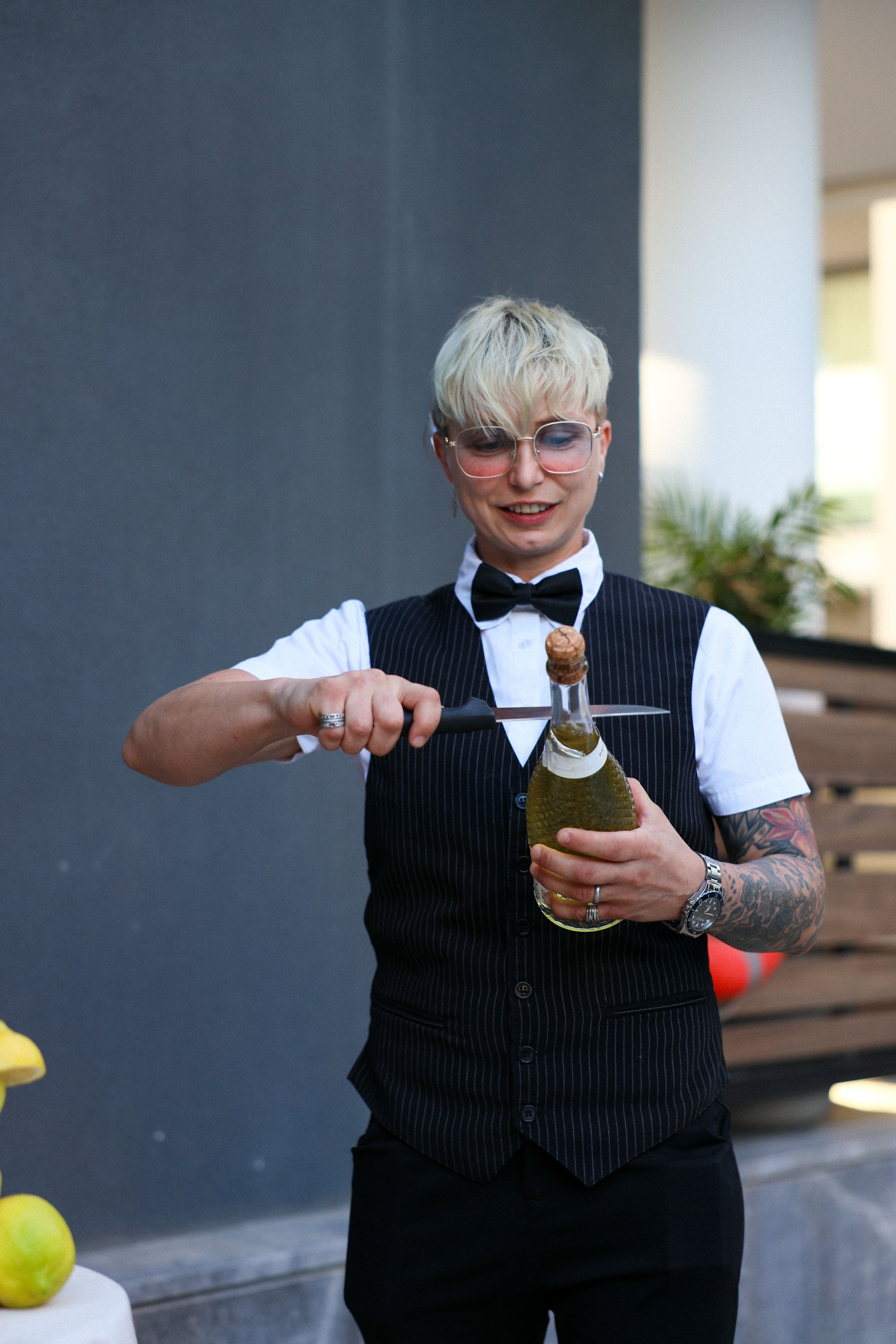 Bartender sabering a bottle of sparkling wine