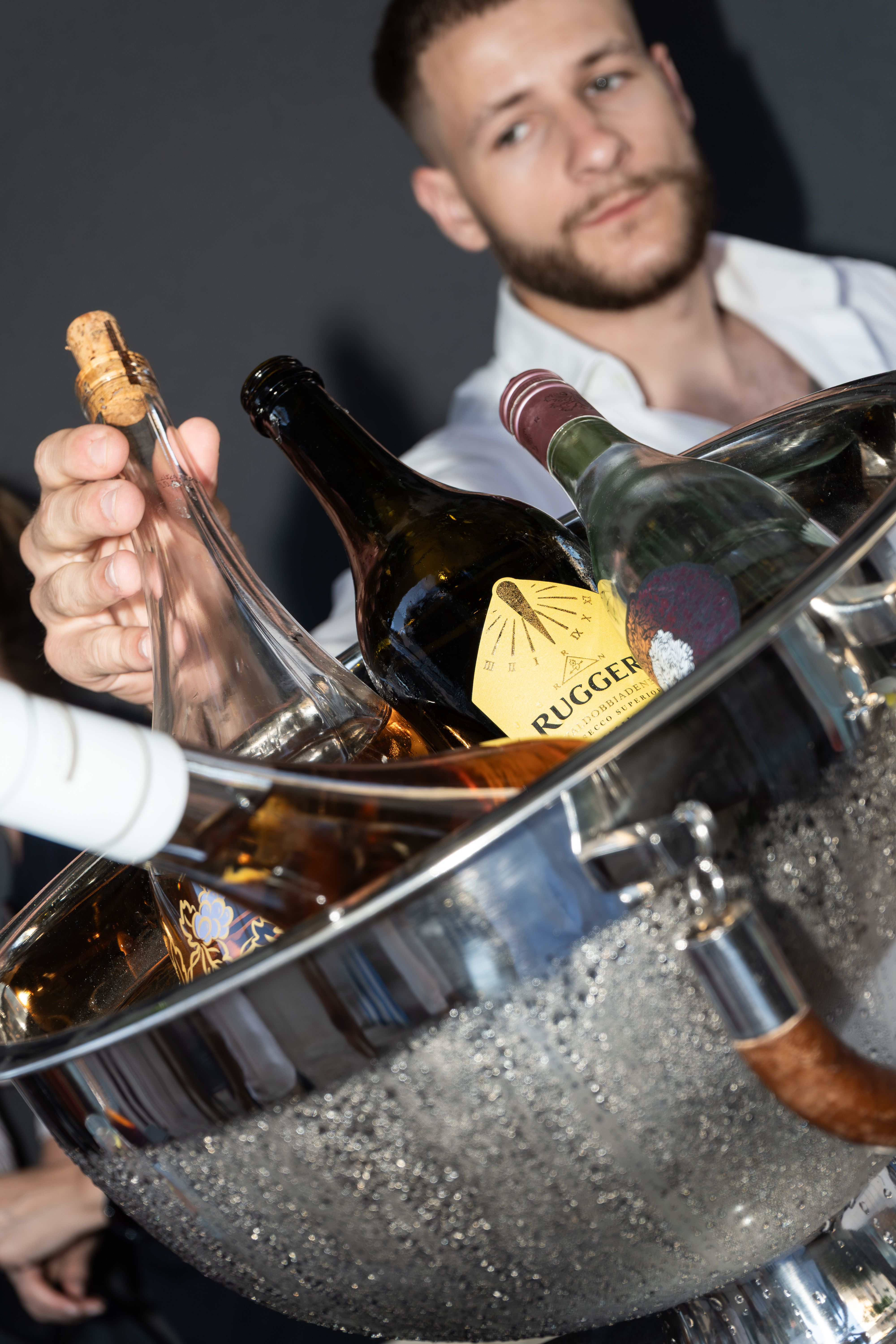 Sparkling wine bottles chilling in a silver ice bowl