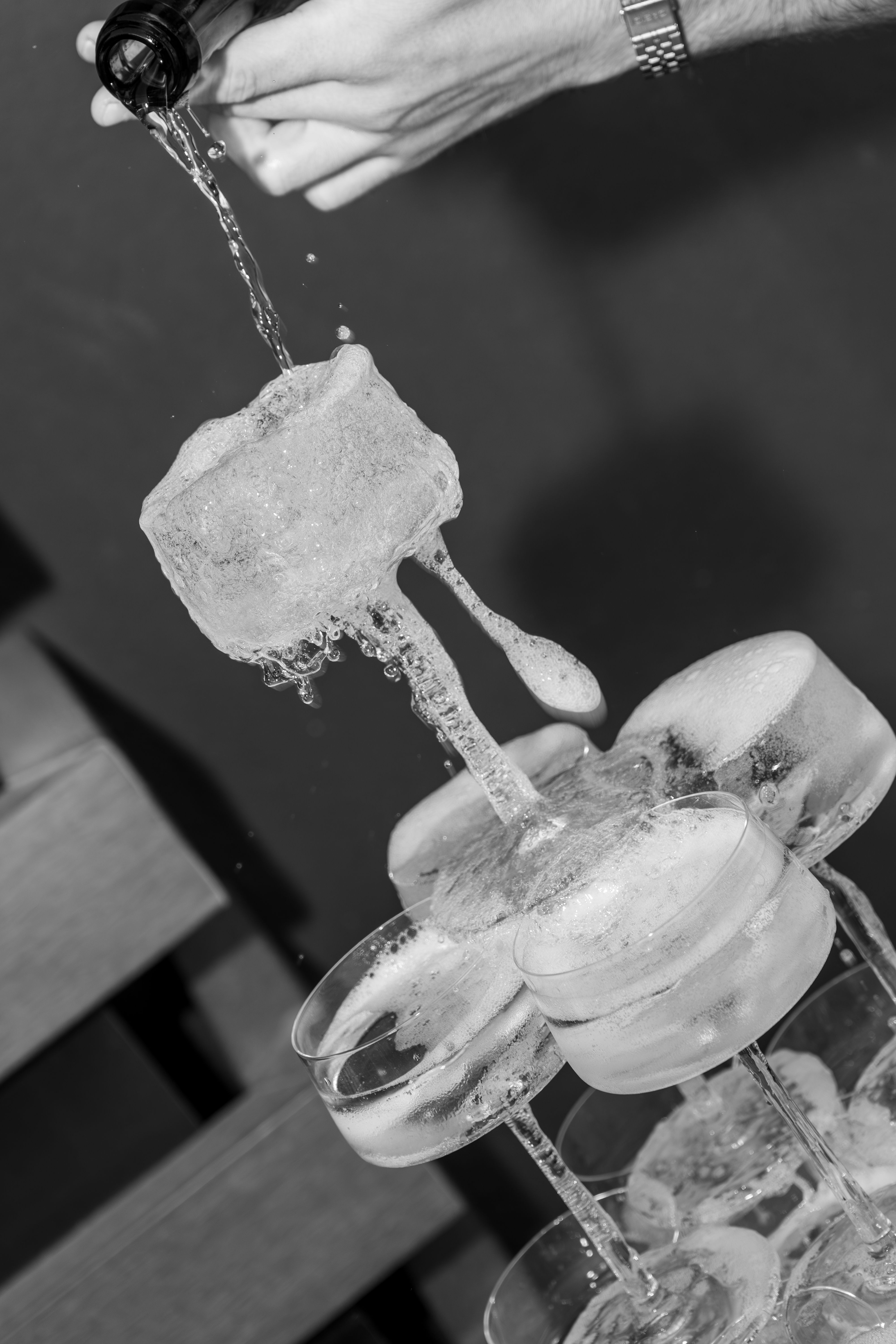 Champagne tower being poured (black and white)