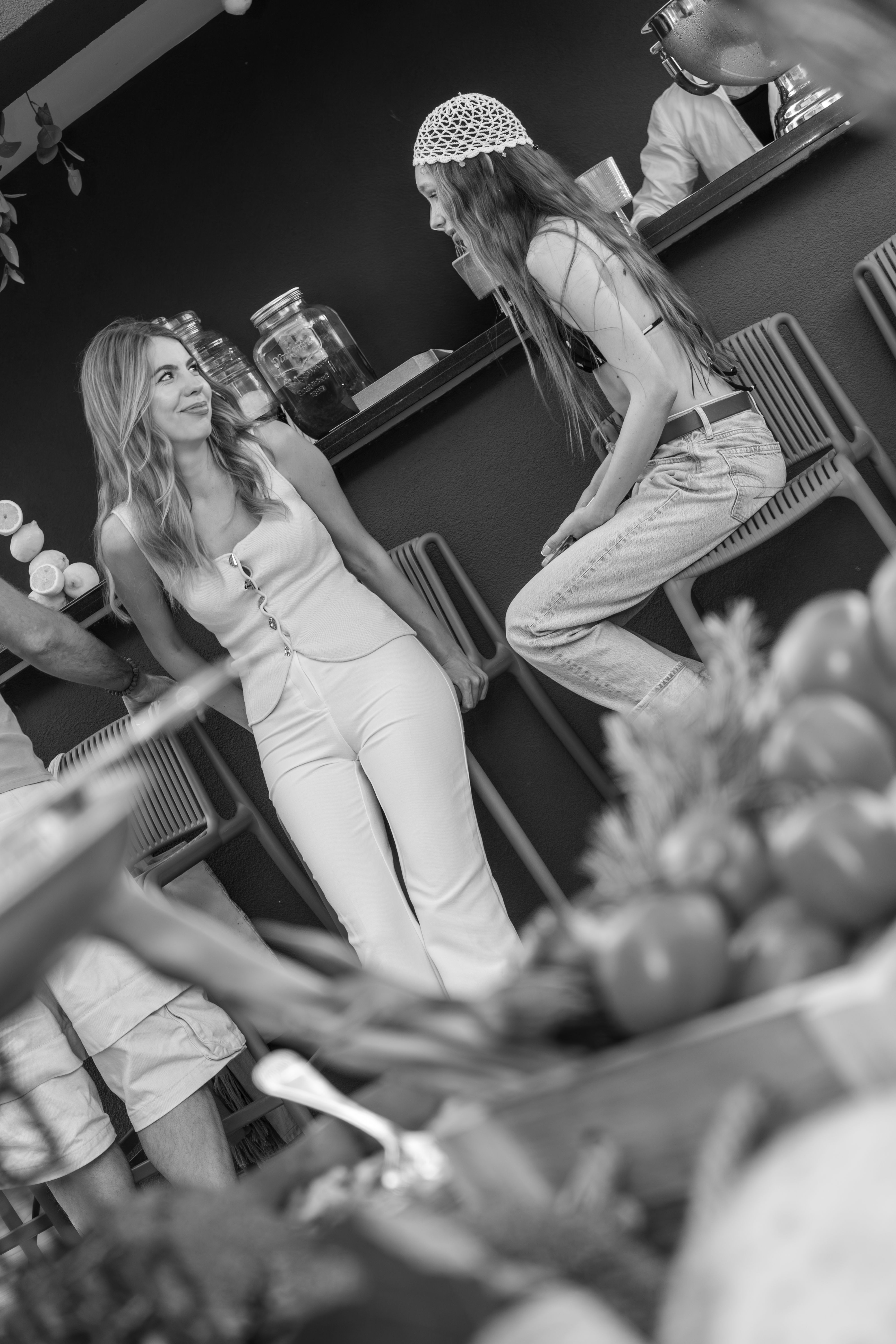 Guests laughing at the bar (black and white)