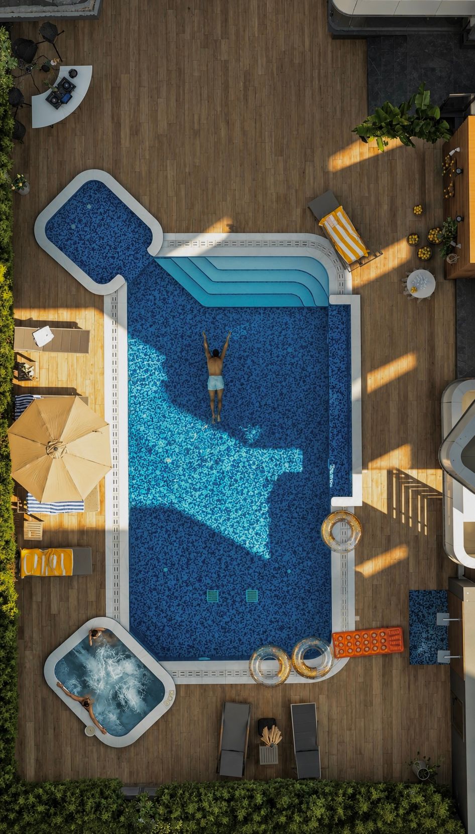 Top-down view of a guest swimming in the 26 Suites pool