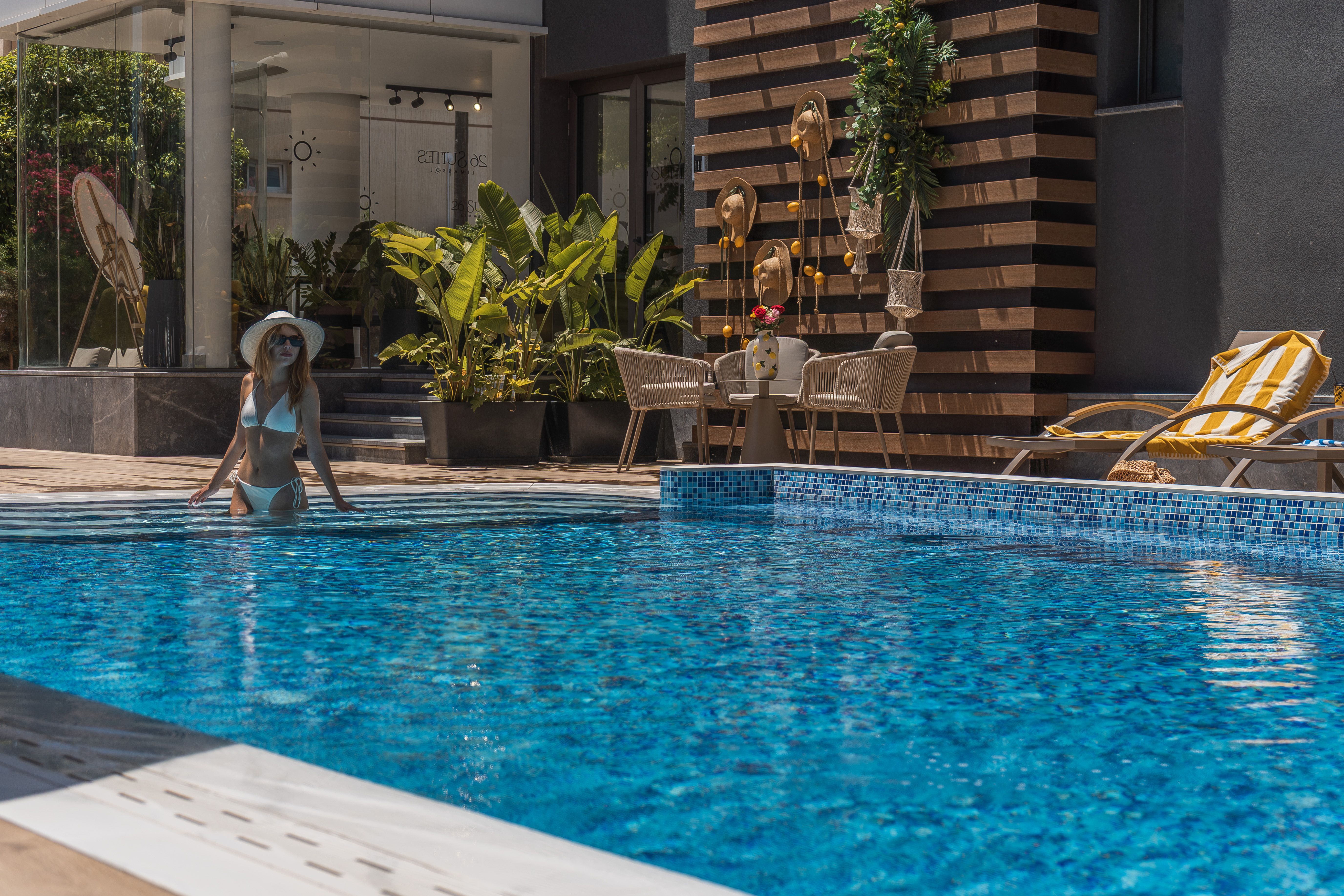 Guest by the pool at the 26 Suites entrance